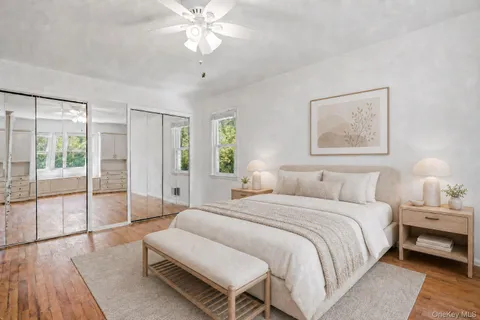 a spacious bedroom with a bed and a chandelier