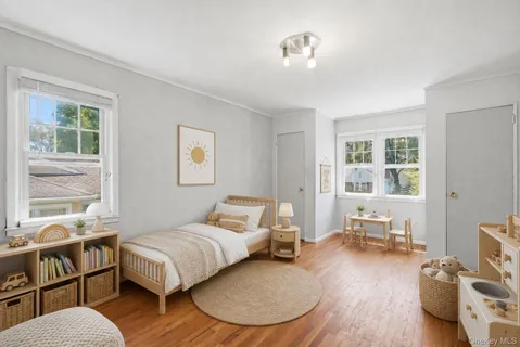 a bedroom with furniture and a wooden floor