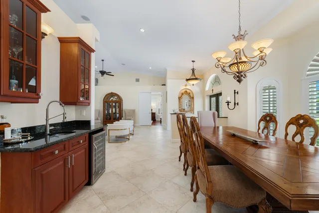 a kitchen with stainless steel appliances granite countertop a stove refrigerator and cabinets