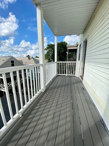 a view of balcony with wooden floor