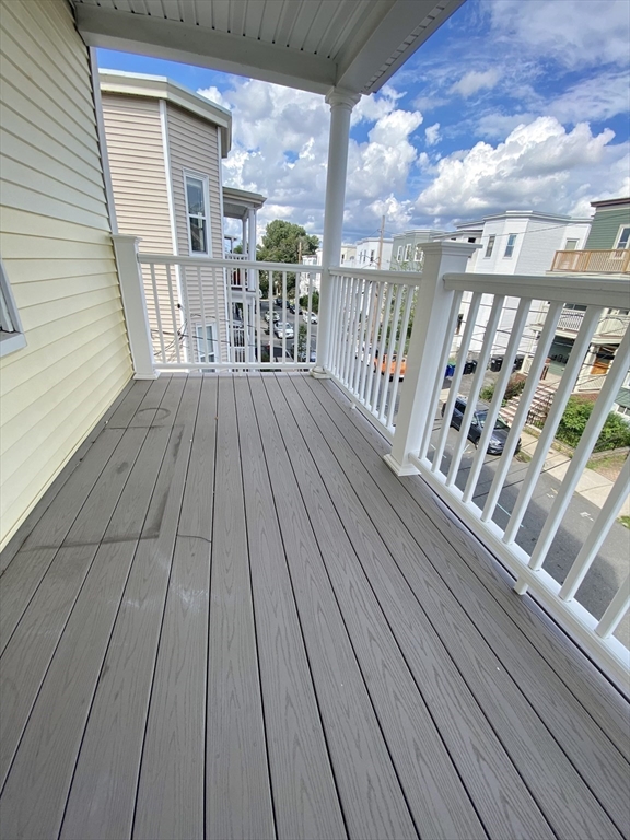 14 Belknap Street, Unit 3 Somerville, MA 02144 - Photo 15 of 25 a balcony with wooden floor