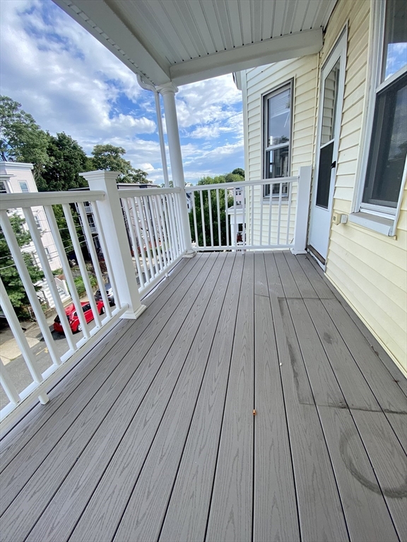 14 Belknap Street, Unit 3 Somerville, MA 02144 - Photo 16 of 25 a view of a balcony with wooden floor