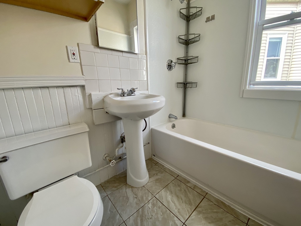 14 Belknap Street, Unit 3 Somerville, MA 02144 - Photo 23 of 25 a bathroom with a sink a toilet and bathtub