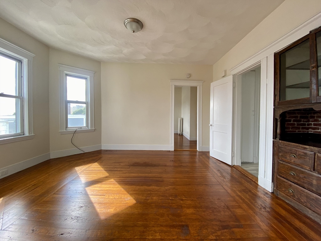 14 Belknap Street, Unit 3 Somerville, MA 02144 - Photo 24 of 25 a view of empty room with wooden floor and fan