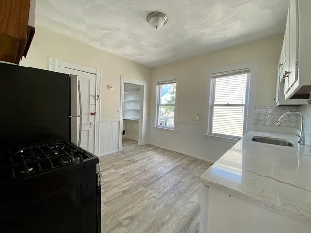 a kitchen with granite countertop a stove and a refrigerator