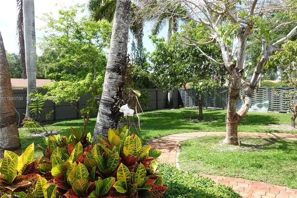 a outdoor space with patio lots of white furniture and umbrella