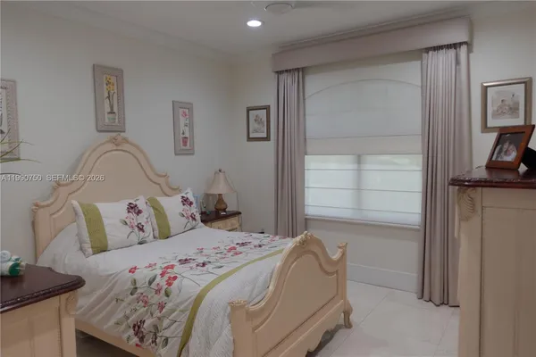 a bedroom with a bed and window