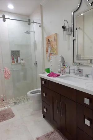 a bedroom with a bed and ceiling fan