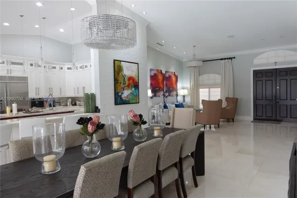 a living room with furniture and painting on the wall