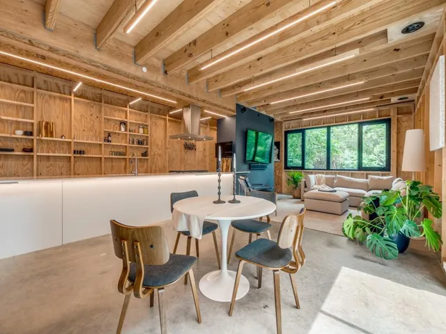 a dining room with furniture and a floor to ceiling window