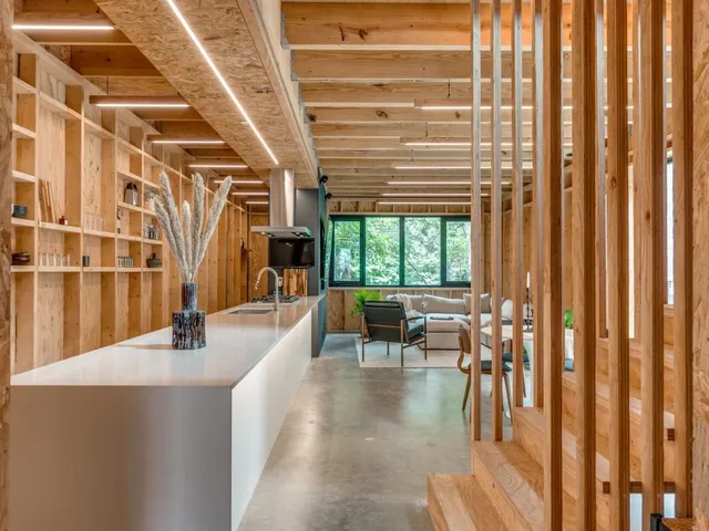 a dining room with furniture and a large window