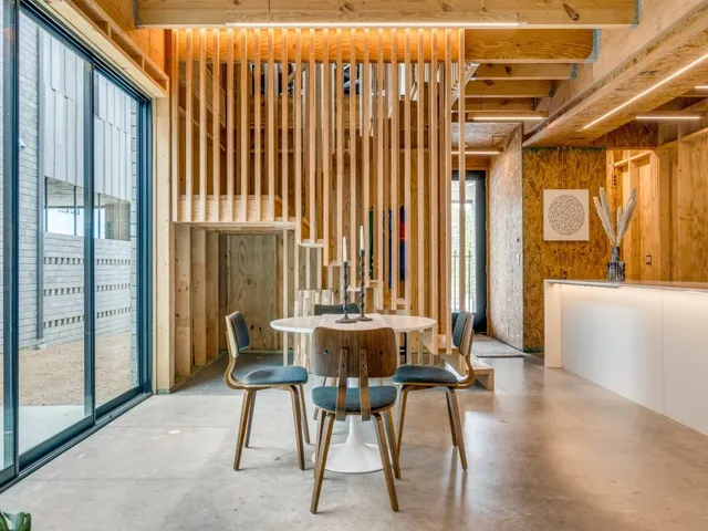 a dining room with furniture and wooden floor