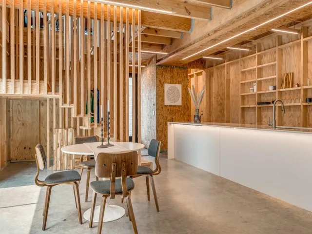 a dining room with furniture and a window
