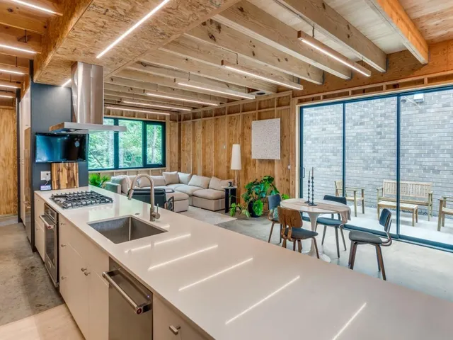 a kitchen with sink and view of living room