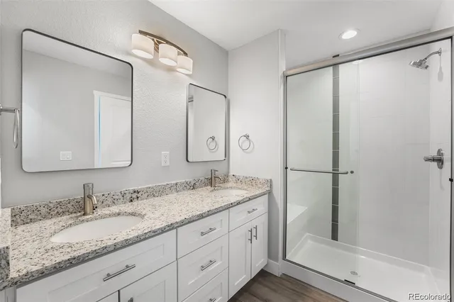 a bathroom with a granite countertop sink mirror and double