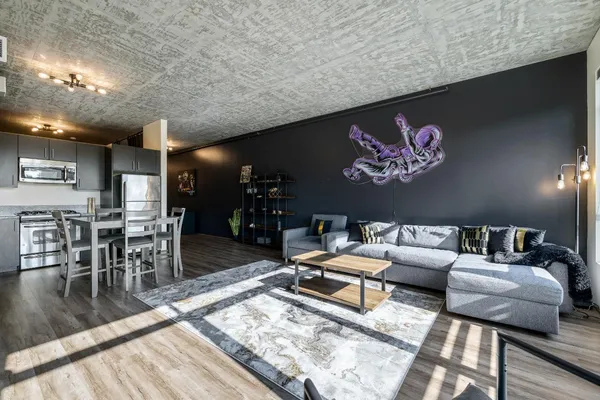 a living room with furniture and a wooden floor