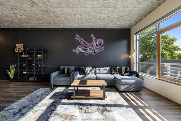 a living room with furniture and a floor to ceiling window