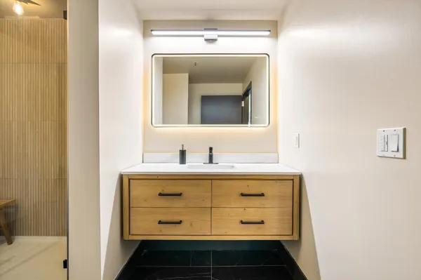 a bathroom with a sink and a mirror