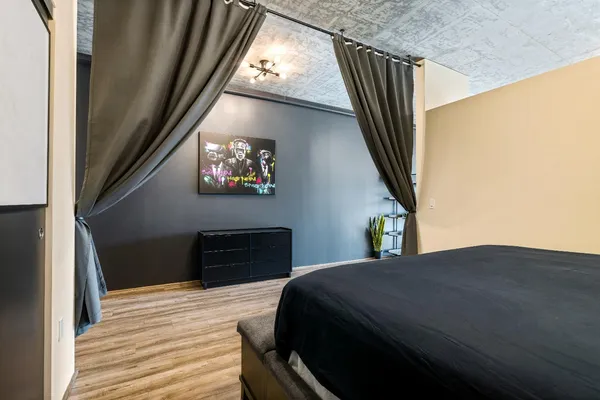 a bedroom with a bed and wooden floor