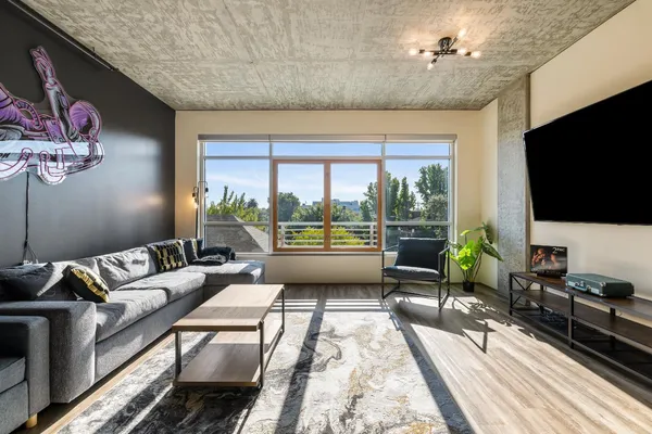 a living room with furniture tv and a flat screen tv