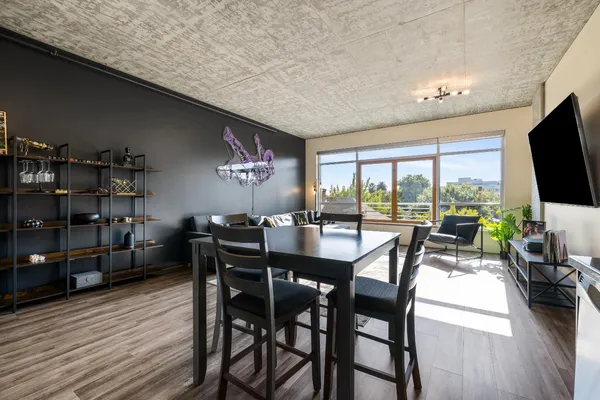 a view of a dining room with furniture window and wooden floor