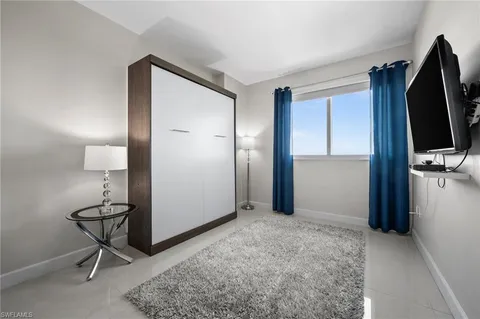 a view of a livingroom with wooden floor and a flat screen tv