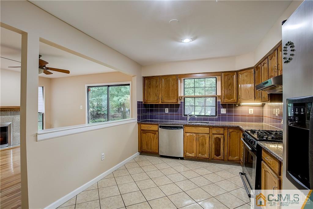 901 Timber Oaks Road Edison, NJ 08820 - Photo 11 of 27 a kitchen with stainless steel appliances granite countertop a stove a sink and a microwave