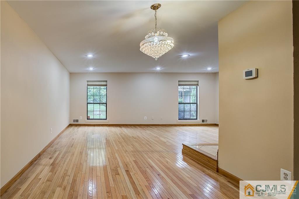901 Timber Oaks Road Edison, NJ 08820 - Photo 14 of 27 a view of an empty room with wooden floor and a window