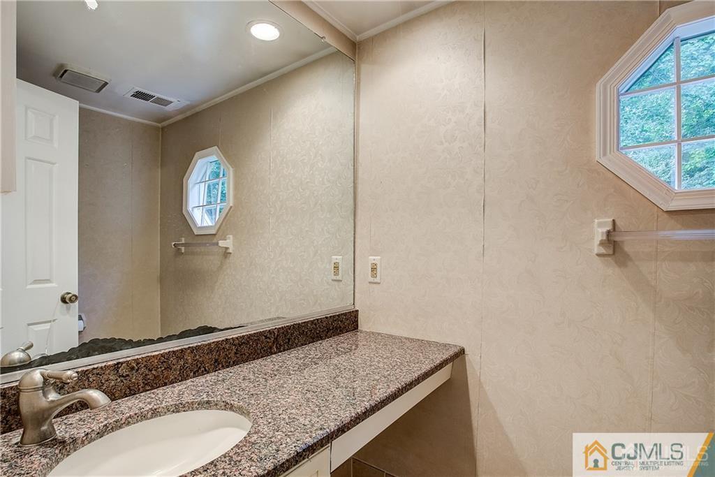 901 Timber Oaks Road Edison, NJ 08820 - Photo 15 of 27 a bathroom with a granite countertop sink and a mirror