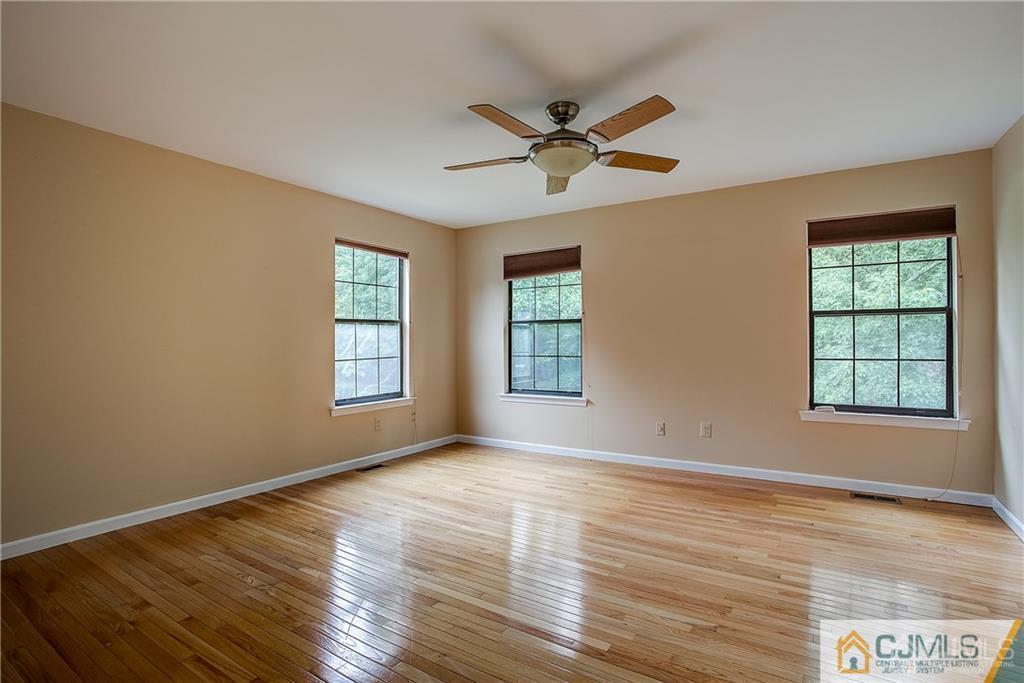 901 Timber Oaks Road Edison, NJ 08820 - Photo 17 of 27 a view of an empty room with wooden floor and a window
