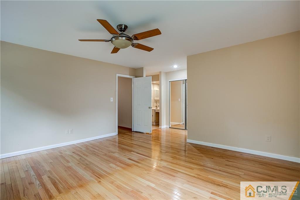 901 Timber Oaks Road Edison, NJ 08820 - Photo 18 of 27 a view of an empty room and wooden floor