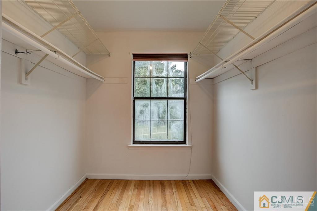 901 Timber Oaks Road Edison, NJ 08820 - Photo 19 of 27 a view of an empty room with wooden floor and a window