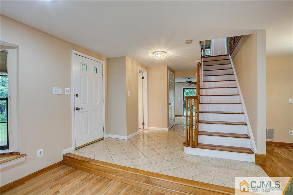 901 Timber Oaks Road Edison, NJ 08820 - Photo 3 of 27 a view of a hallway with entryway and hall with wooden floor