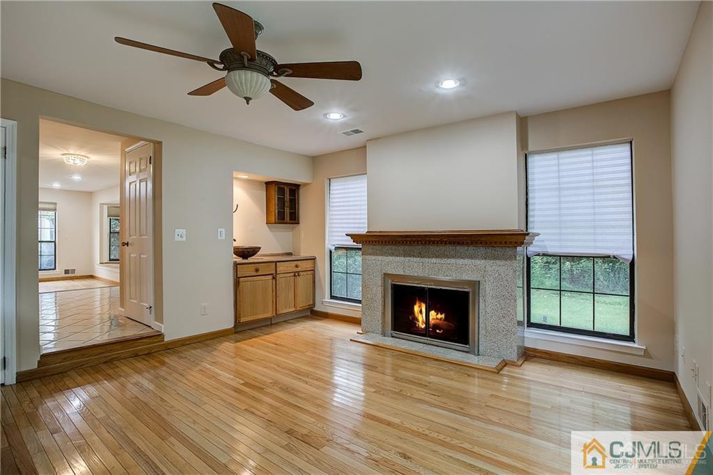 901 Timber Oaks Road Edison, NJ 08820 - Photo 8 of 27 a living room with stainless steel appliances furniture a fireplace and wooden floor