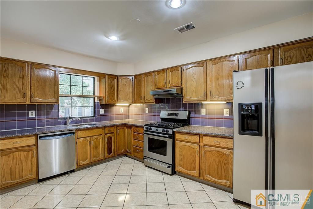901 Timber Oaks Road Edison, NJ 08820 - Photo 10 of 27 a kitchen with stainless steel appliances granite countertop a stove a sink dishwasher a refrigerator and a microwave