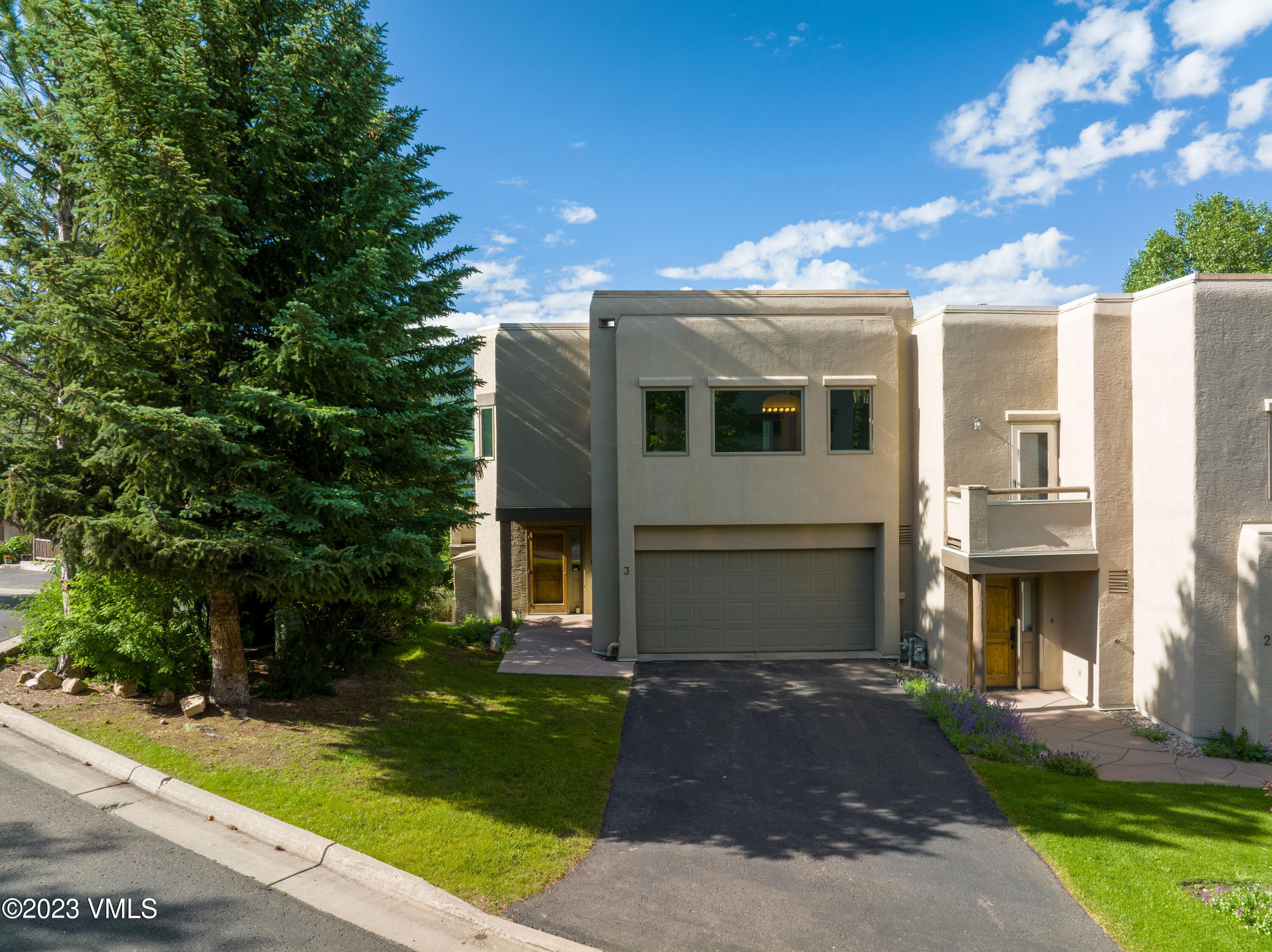 751 Singletree Road, Unit 3 Edwards, CO 81632 - Photo 1 of 22 a front view of a house with garden
