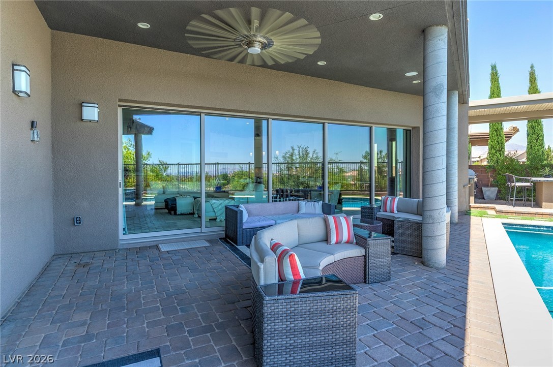 6014 Willow Ridge Court Las Vegas, NV 89135 - Photo 73 of 99 Relax in this inviting outdoor oasis, featuring a covered patio and sparkling swimming pool.
