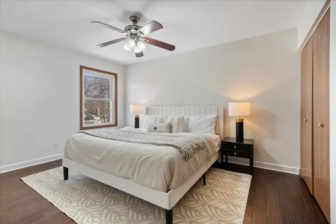 a bedroom with a large bed and a chandelier