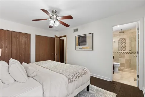 a bedroom with a large bed and a chandelier