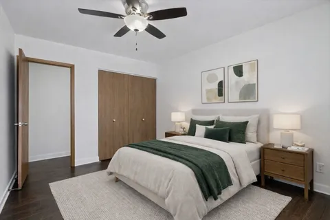 a bedroom with a bed and wooden floor