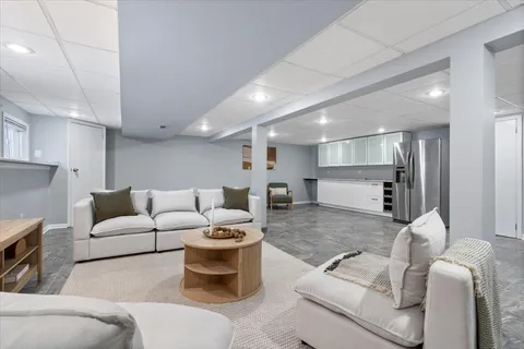 a living room with furniture and a view of kitchen