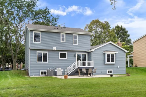 a front view of a house with a yard and trees