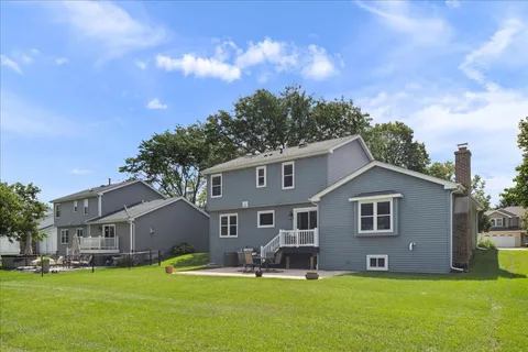 a front view of a house with a yard and trees