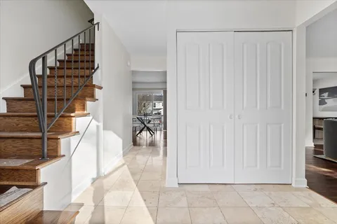 a view of entryway with wooden floor and stairs