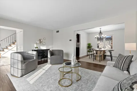 a living room with furniture rug and dining table