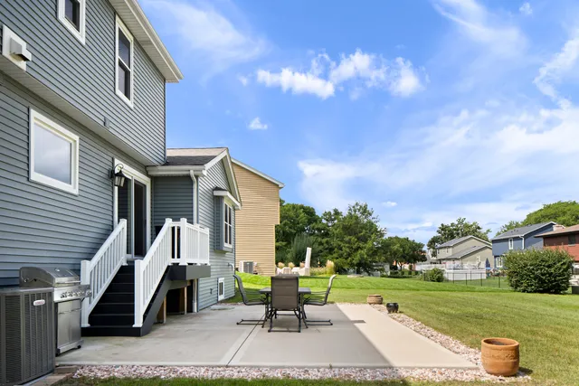 a view of a patio with a table and chairs