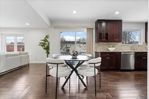 a view of a dining room with furniture and wooden floor