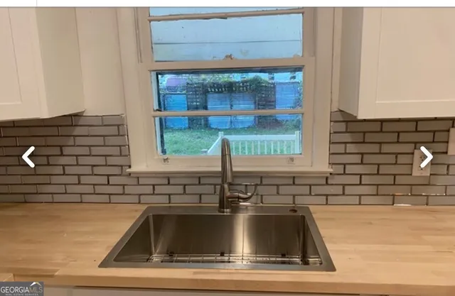 a kitchen sink with a granite countertop window