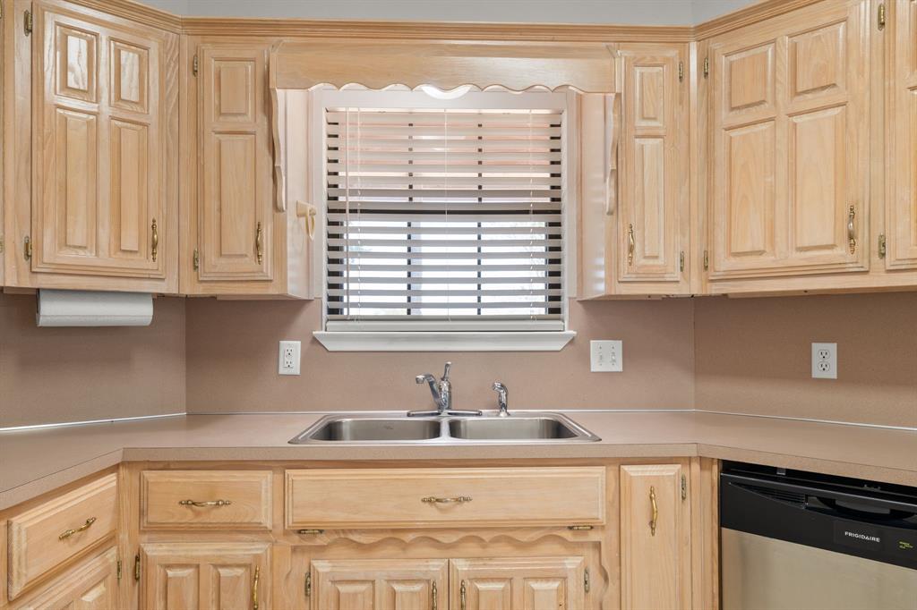 162 Warren Road Lorena, TX 76655 - Photo 17 of 39 Kitchen featuring wood cabinetry, a double basin stainless steel sink, countertop space, and a built-in dishwasher
