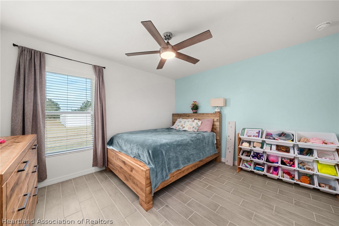 1204 Ridge Drive Avon Park, FL 33825 - Photo 11 of 20 a bedroom with bed and a chandelier